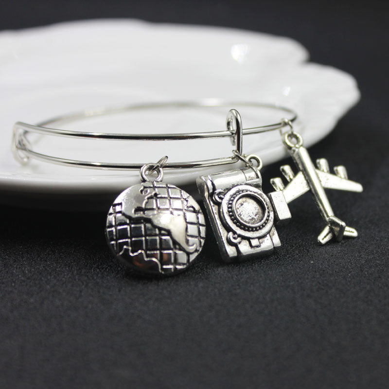 Silver Wanderlust Bracelet with World, Airplane Camera – Globe